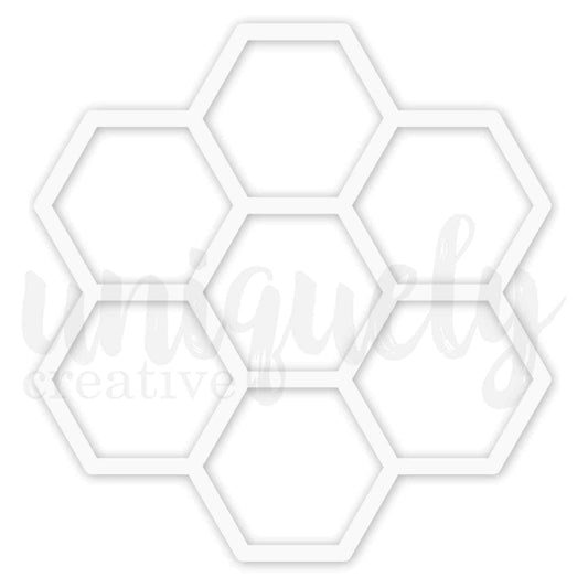 Uniquely Creative Honeycomb Overlay approximately 8x8 inch white chipboard overlay featuring seven large open hexagons arranged in a honeycomb cluster shape 