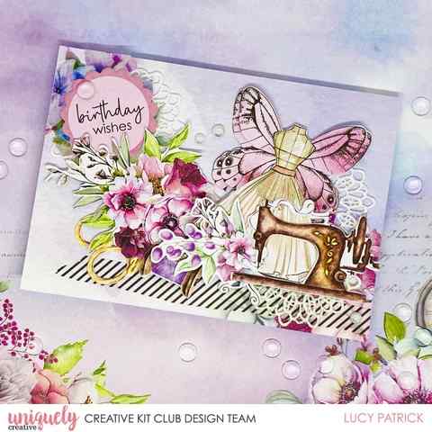 Handmade birthday card with a butterfly, sewing machine and floral arrangement, finished with a lace doily accent