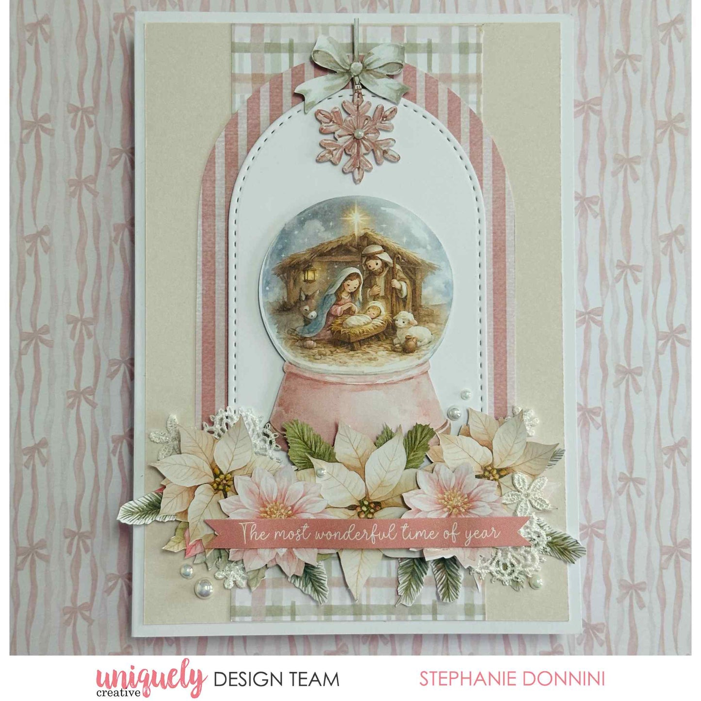 Handmade Christmas card featuring a nativity scene snow globe, pink poinsettias, and the sentiment "The most wonderful time of year" made with Uniquely Creative Little Festive Things