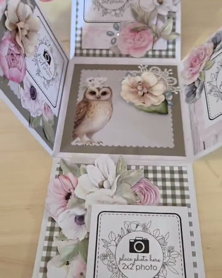 Open white memory box folio showing interior with owl decoration, floral embellishments, and multiple photo placement areas demonstrating 3D cube design