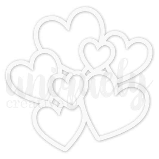  Uniquely Creative Oh So Lovely Hearts Overlay white cardstock showing a cluster of 7 layered heart outlines in varying sizes, approximately 9 by 9 inches