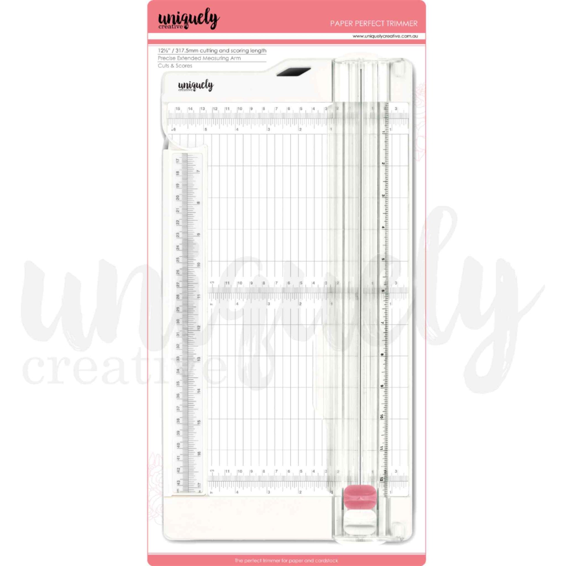 Uniquely Creative Paper Perfect Trimmer in packaging — lightweight paper trimmer with 12½ inch cutting length, extended measuring arm, metric and imperial grid, includes cutting and scoring blades