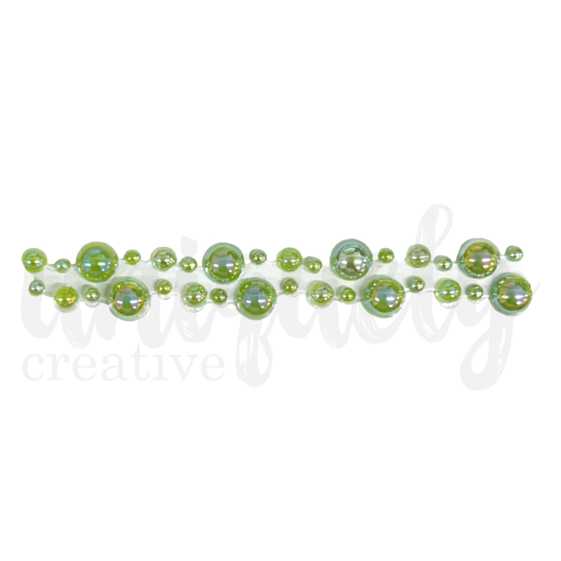 Close-up of sage green pearl tape showing graduated sizes of iridescent acrylic pearls arranged in decorative pattern on adhesive strip for card making and scrapbooking 