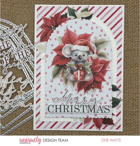 Christmas card sample using Uniquely Creative Scalloped Arches Die with layered white scalloped arches framing Santa koala with present, red poinsettias and Merry Christmas sentiment on striped background