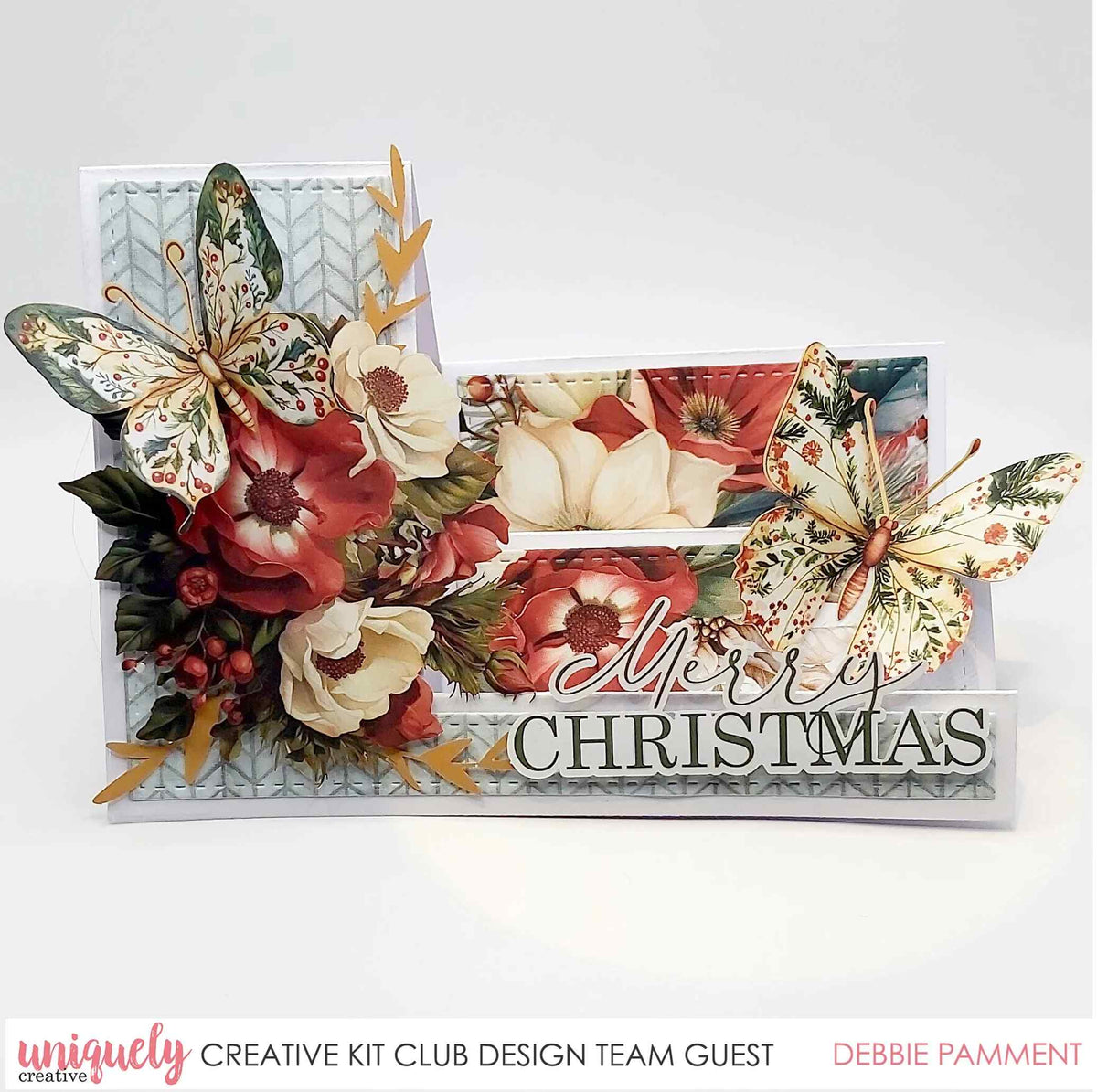 Christmas side stepper card with red and cream flowers, two patterned butterflies and a Merry Christmas sentiment