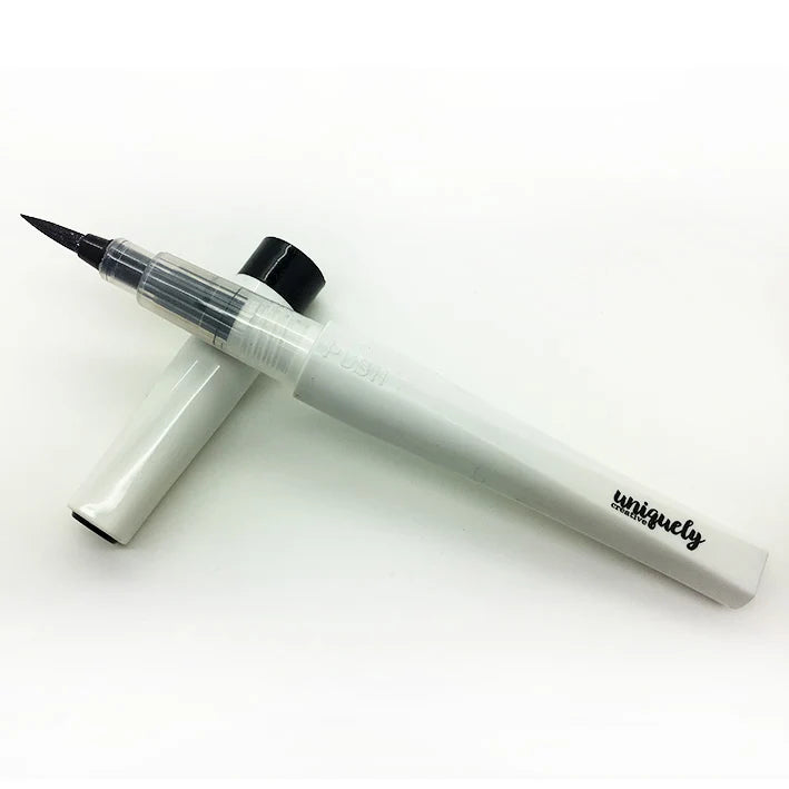 Uniquely Creative Black Sparkle Brush with cap removed, showing fine brush tip