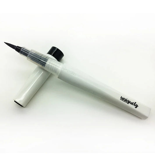 Uniquely Creative Black Sparkle Brush with cap removed, showing fine brush tip