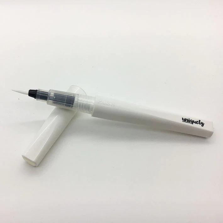Uniquely Creative Clear Sparkle Brush with cap removed, showing fine brush tip