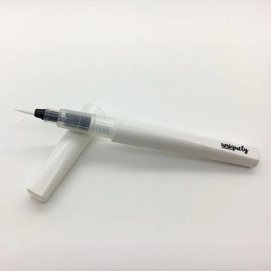 Uniquely Creative Clear Sparkle Brush with cap removed, showing fine brush tip