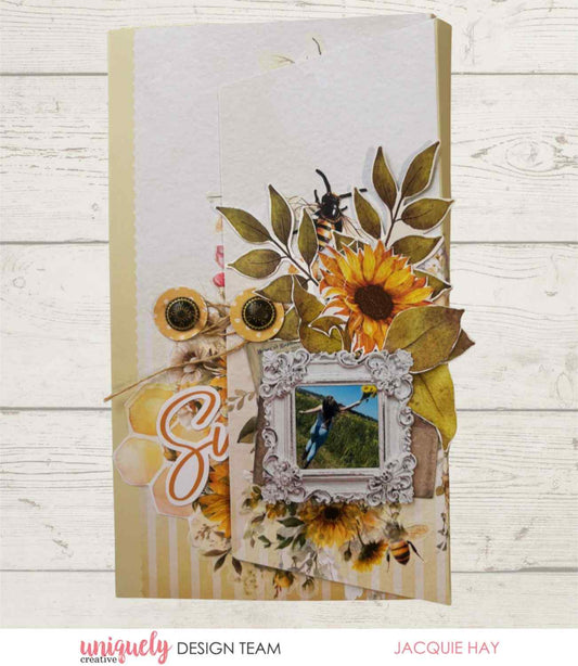 Uniquely Creative Sweet As Honey fold-out album sample showing cover decorated with sunflowers, bees, leaves, and a framed photo, created by Jacquie Hay