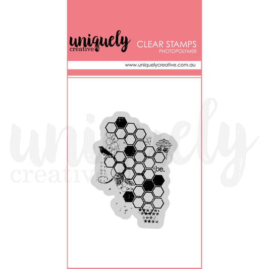 Uniquely Creative Sweet As Honey Botanical Honeycomb clear photopolymer stamp showing an irregular honeycomb hexagon grid overlaid with vintage ephemera details including a perched bird, botanical sprig, aged postage label, alphabet letters, star row, cross marks, and the word "be" 