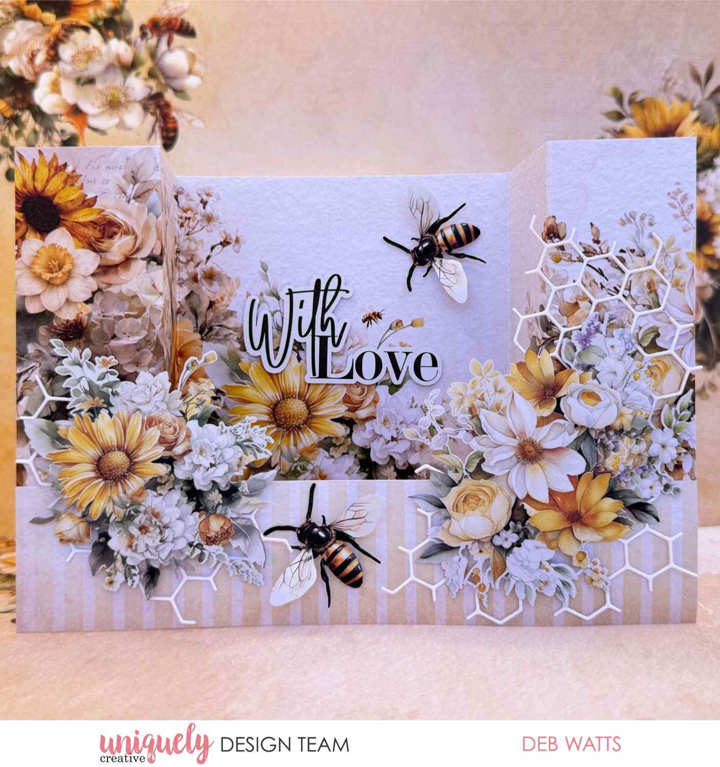 Uniquely Creative Sweet As Honey gatefold card with "With Love" sentiment, layered sunflowers, daisies, roses, honeycomb die cuts, and bee embellishments, created by Deb Watts