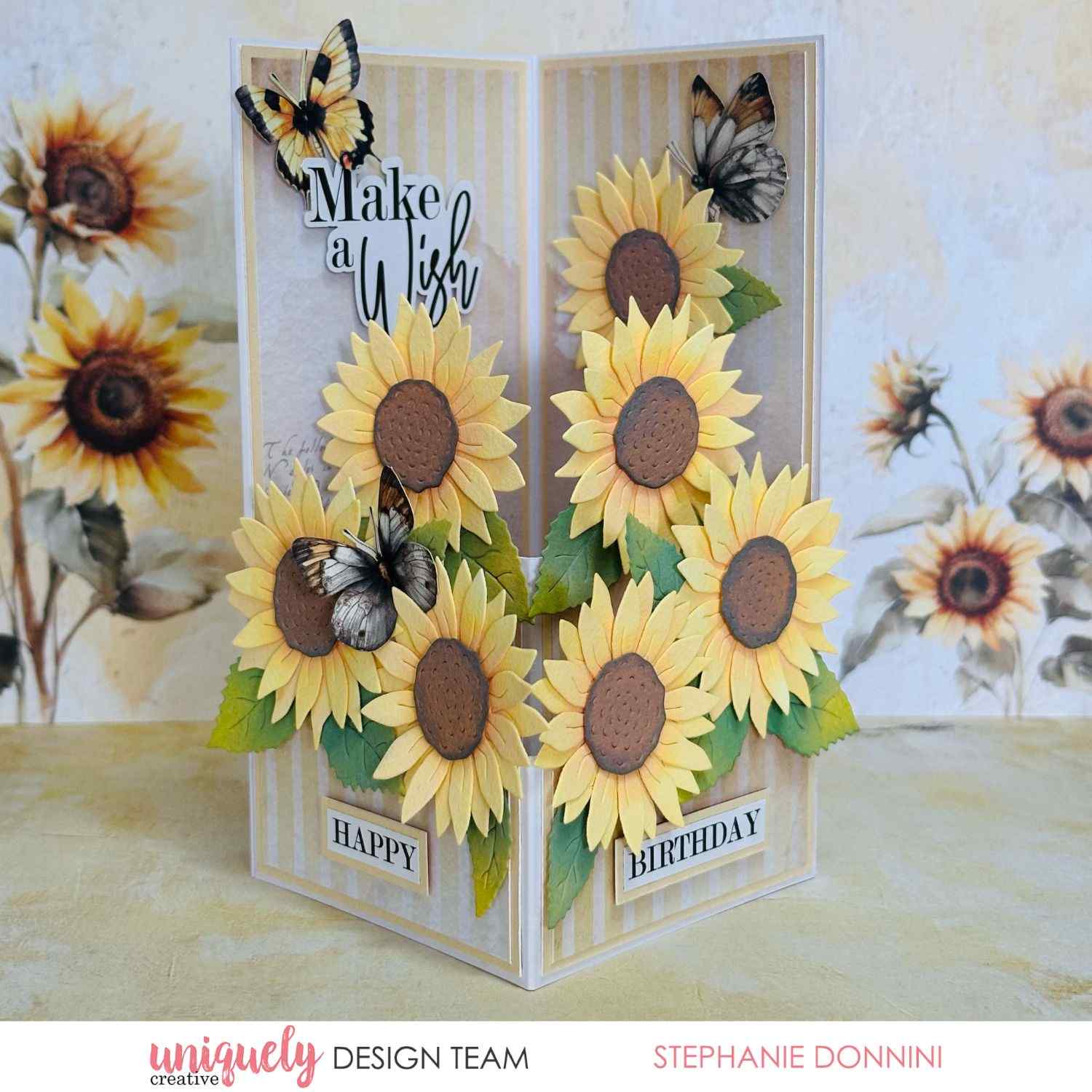 Uniquely Creative Sweet As Honey tri-fold standing card with "Make a Wish" and "Happy Birthday" sentiments, layered die-cut sunflowers, leaves, and butterfly embellishments, created by Stephanie Donnini