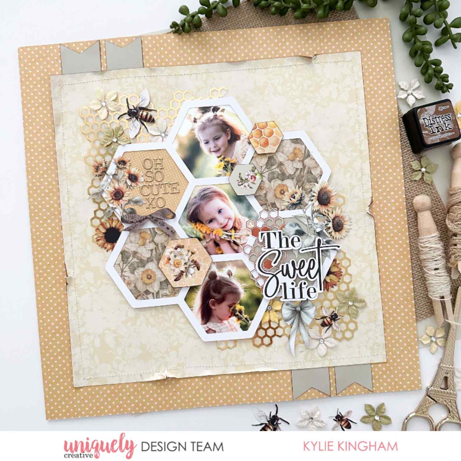 Uniquely Creative Sweet As Honey scrapbook layout with hexagon photo cluster, "The Sweet Life" sentiment, honeycomb die cuts, sunflowers, bees, and three photos of a child, created by Kylie Kingham