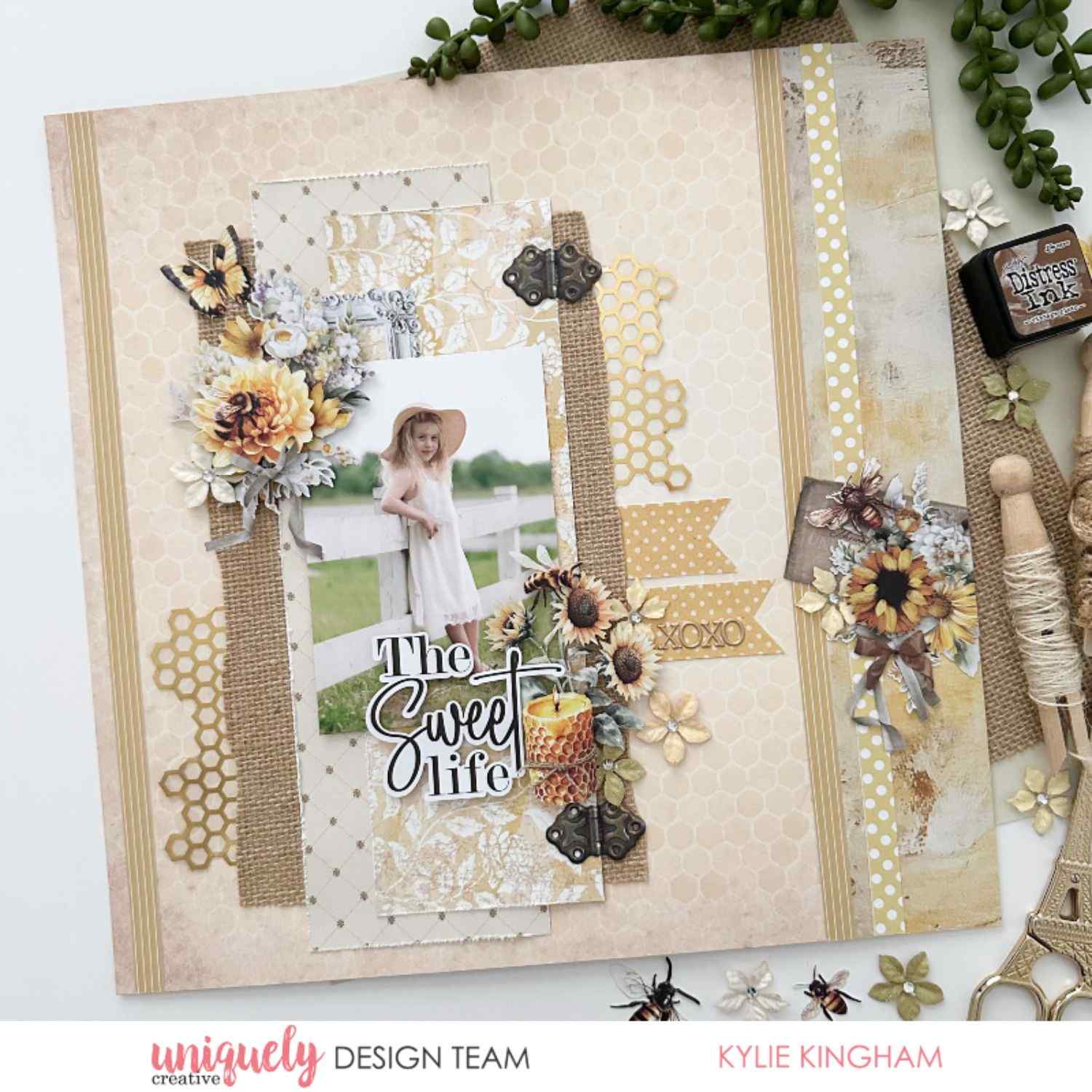 Uniquely Creative Sweet As Honey scrapbook layout with "The Sweet Life" sentiment, layered papers, burlap strips, honeycomb die cuts, sunflowers, and a child photo in a vintage-style frame, created by Kylie Kingham