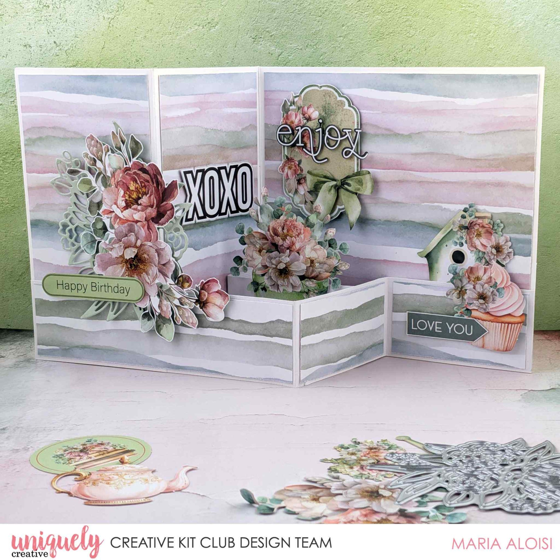 Tea and Tranquility z-fold card by Uniquely Creative Kit Club design team — multi-panel z-fold card featuring watercolour stripe papers, lush peony clusters, birdhouse and cupcake die-cuts, and "XOXO," "Enjoy," "Happy Birthday," and "Love You" sentiments in soft blush, dusty rose, and sage 