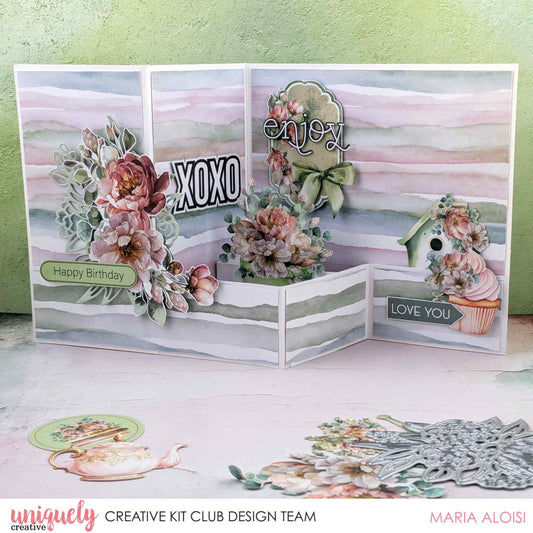 Tea and Tranquility z-fold card by Uniquely Creative Kit Club design team — multi-panel z-fold card featuring watercolour stripe papers, lush peony clusters, birdhouse and cupcake die-cuts, and "XOXO," "Enjoy," "Happy Birthday," and "Love You" sentiments in soft blush, dusty rose, and sage 