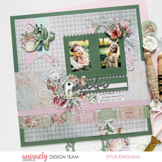 Tea and Tranquility scrapbook layout by Uniquely Creative design team — "Wonder" children's memory page featuring birdhouse and butterfly die-cuts, botanical clusters, ticket strip embellishments, and soft journaling in sage, blush, and dusty pink 