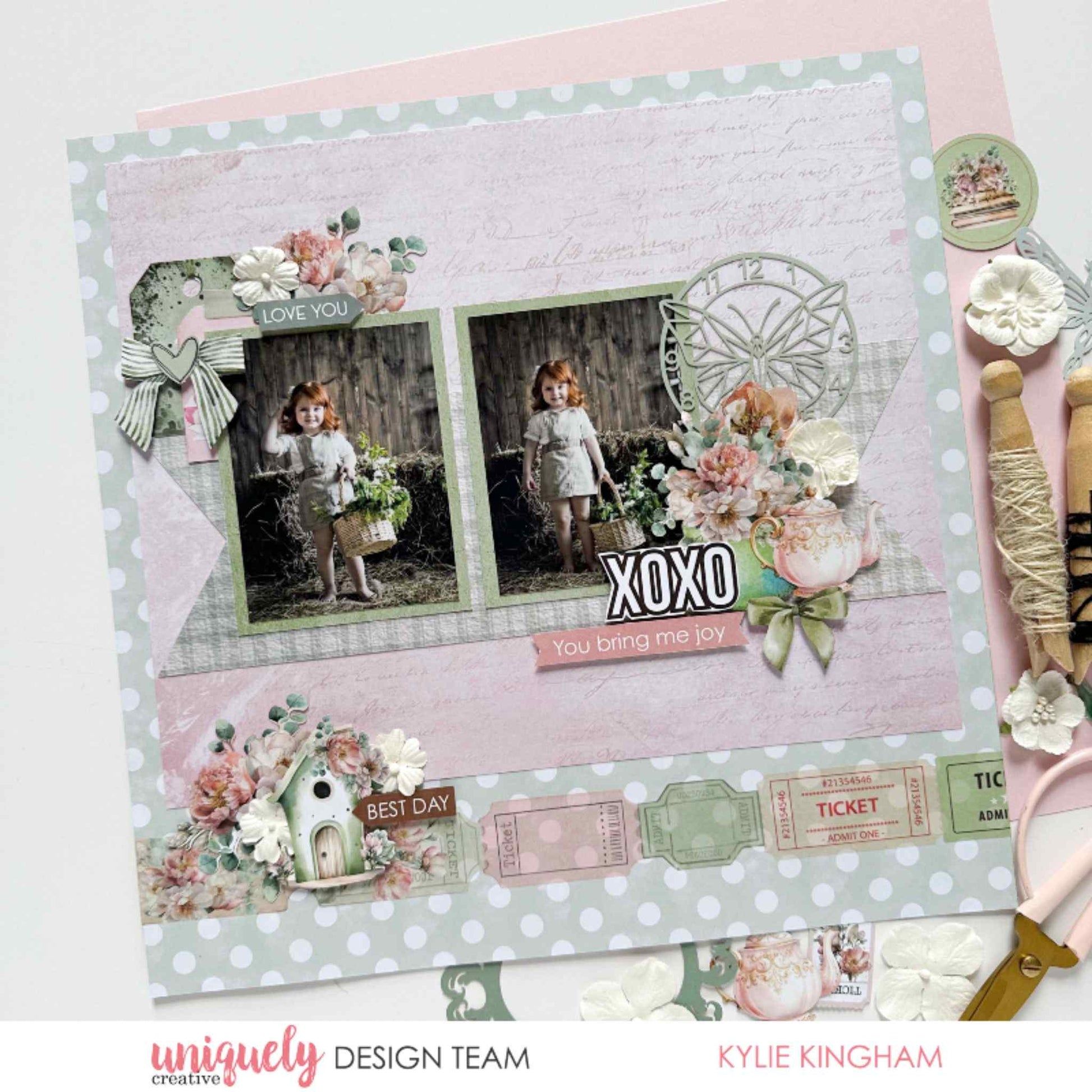 Tea and Tranquility scrapbook layout by Uniquely Creative design team — "XOXO You Bring Me Joy" children's memory page featuring polka dot and script papers, birdhouse cluster, butterfly clock die-cut, ticket embellishments, and pink floral clusters in blush, sage, and soft pink 