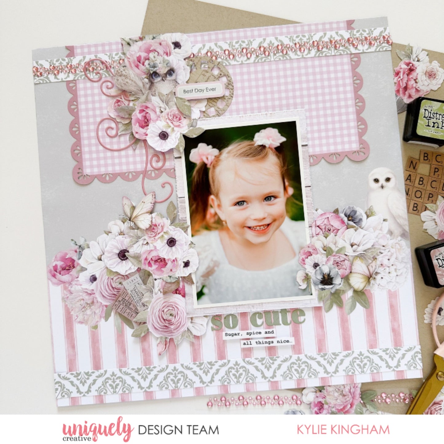 12x12 scrapbook layout using Uniquely Creative Whispers of Wisdom collection featuring child's photo with watercolour florals in blush pink and white, pink gingham check pattern, pink stripe paper, green damask border, pink flourish stickers, rhinestone embellishments, and so cute sentiment tag