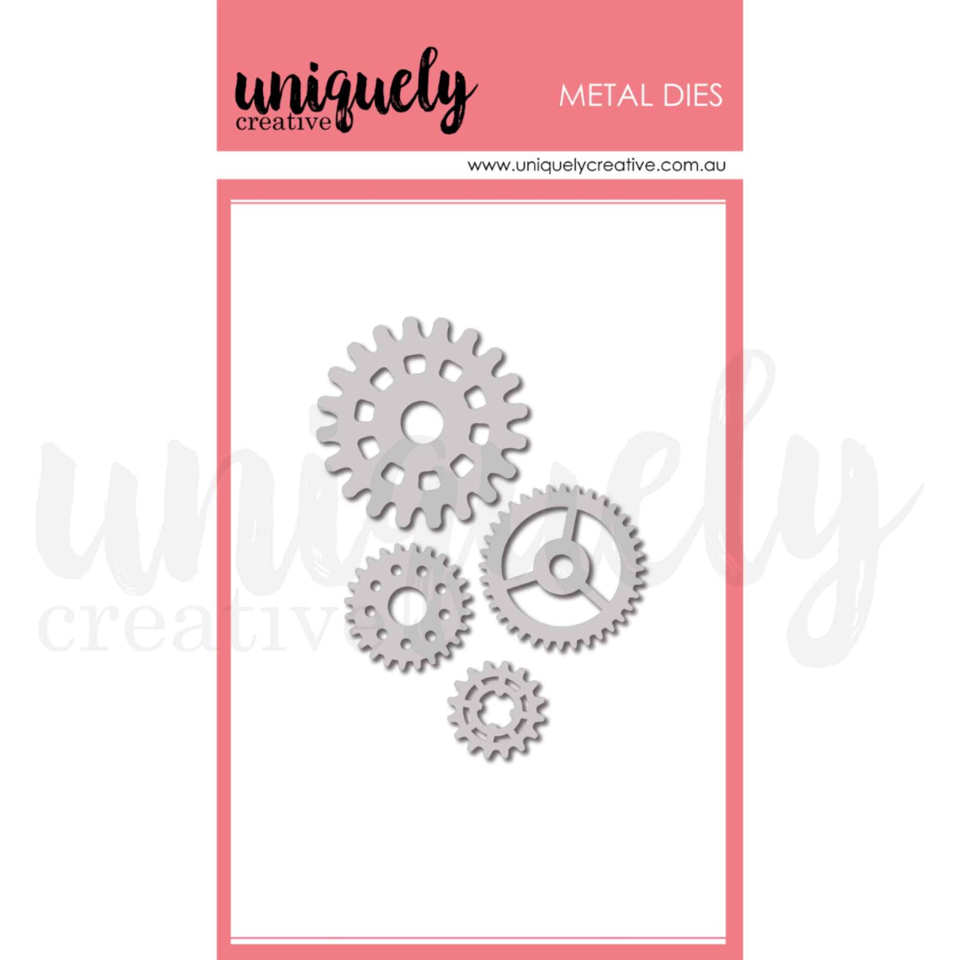 Uniquely Creative Cogs Die UCD2241 metal die set showing four gear cog dies in sizes approximately 3/4 inch, 1 inch, 1.5 inch and 1.75 inch including a detailed spoked wheel cog design