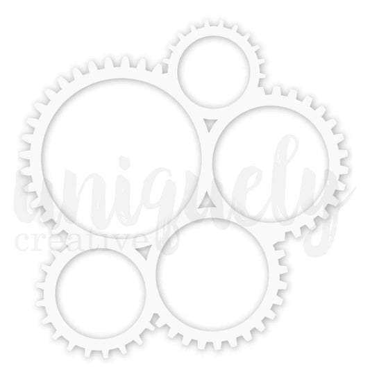 Uniquely Creative Cogs Overlay white laser-cut overlay approximately 7.5 inches square featuring five interlocking gear cogs in varying sizes