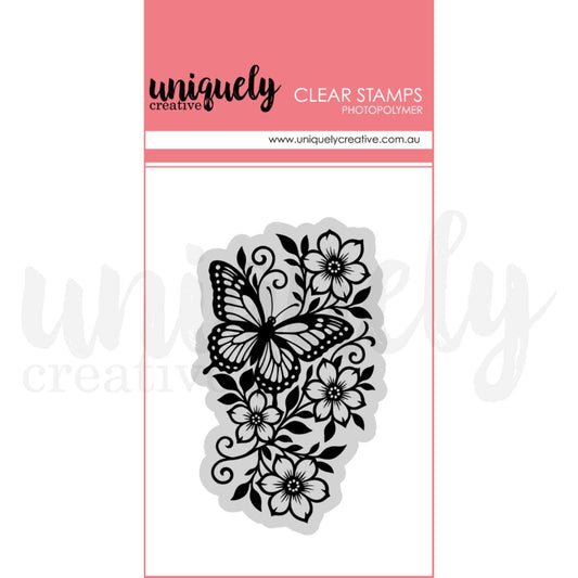 Wings and Wildflowers photopolymer clear stamp by Uniquely Creative — detailed butterfly and wildflower botanical stamp featuring a monarch butterfly among open blooms, swirling vines, and layered leaves