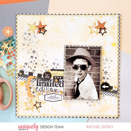 Limited edition scrapbook layout with black and white photo on pale yellow textured background featuring Uniquely Creative Written in the Stars collection with cascading star stencilling, black gingham border and Here and Now sentiment