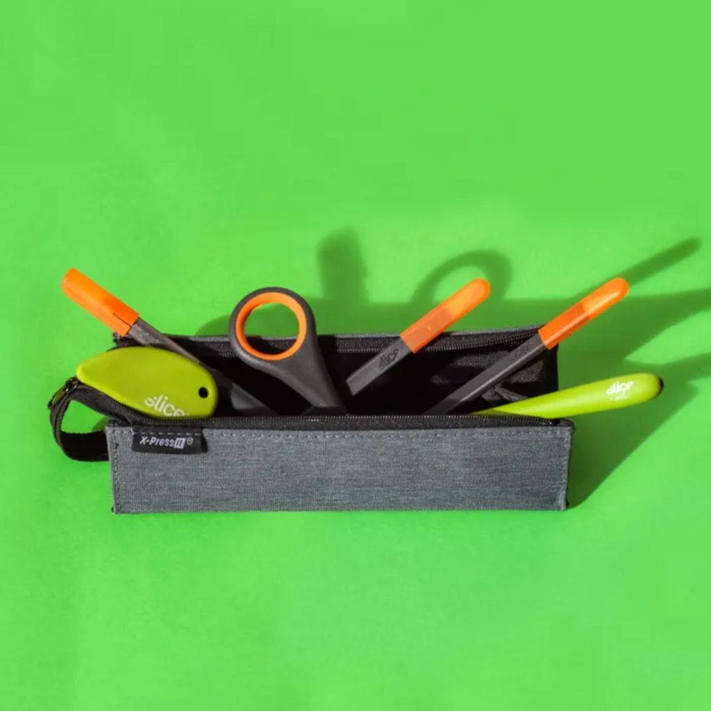Black tool pouch with orange-handled tools on a green background